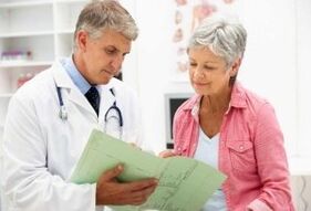 A woman suffering from arthritis during an appointment with the doctor